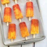 Mangonada popsicles displayed on a cookie sheet