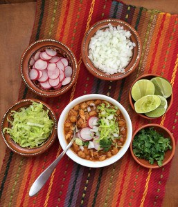 Pozole rojo is a hearty classic Mexican soup or stew, traditionally made with pork broth, pork, hominy, and spices, then topped with garnishes such as lime juice, radishes, onion, lettuce and more. It's a popular traditional dish served throughout the country that is representative of Mexican cuisine. Here's how to make pozole rojo in your slow-cooker with a semi-homemade cheat via theothersideofthetortilla.com.