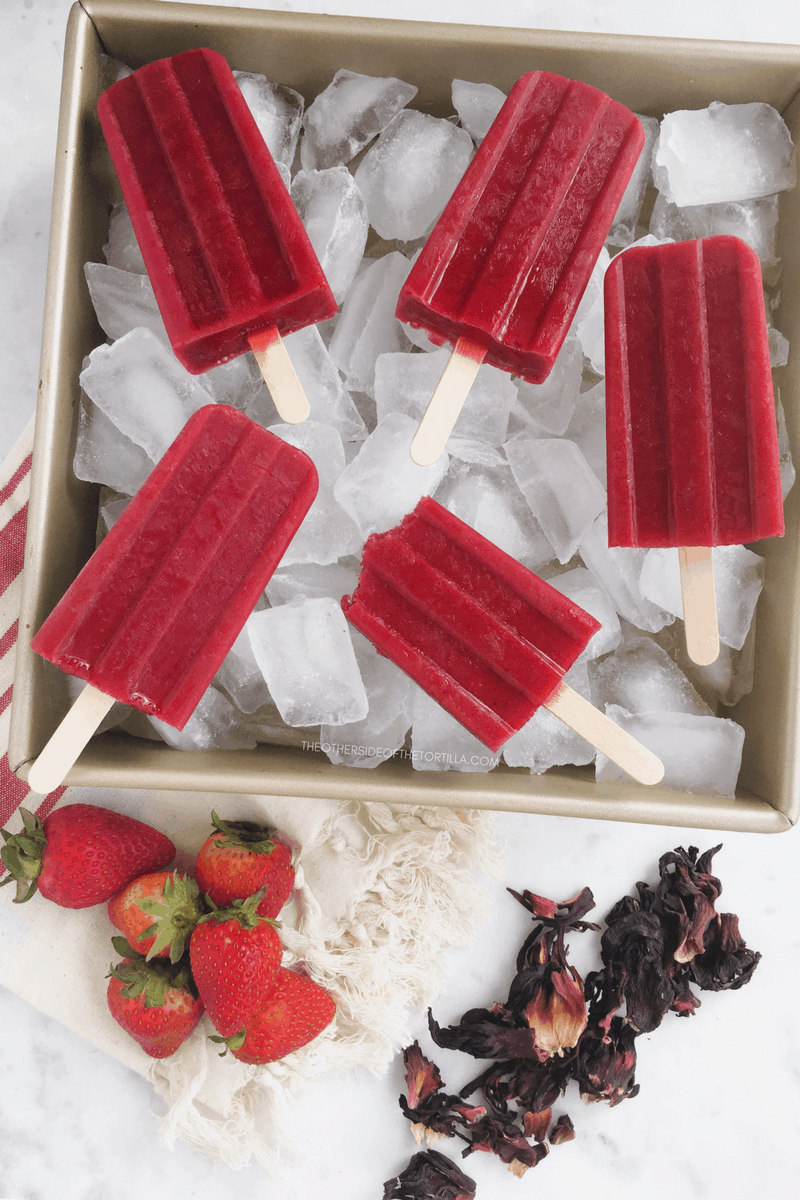 How to make strawberry hibiscus popsicles via theothersideofthetortilla.com