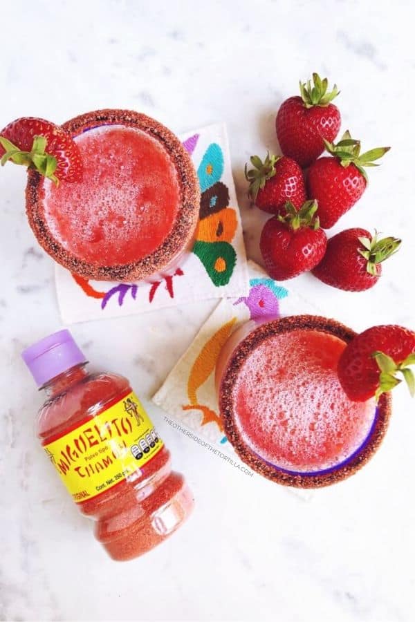 Slushy strawberry margaritas with chamoy for rimming the glasses