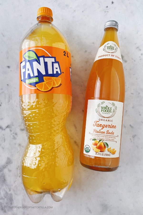 Bottles of European orange Fanta and Whole Foods organic Tangerine Italian soda