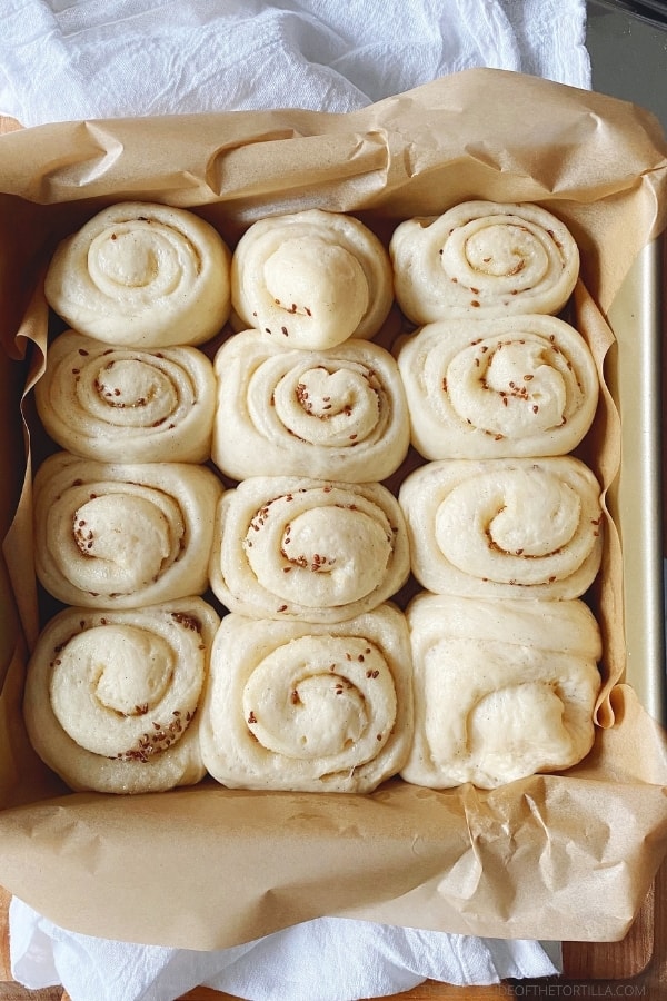 Unbaked anise rolls in a square baking pan 