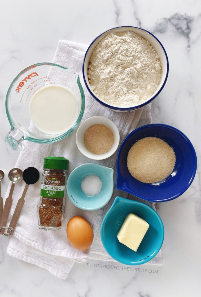 Ingredients, clockwise, from top left: milk, bread flour, instant yeast, sugar, kosher salt, butter, egg, anise seeds, vanilla bean paste