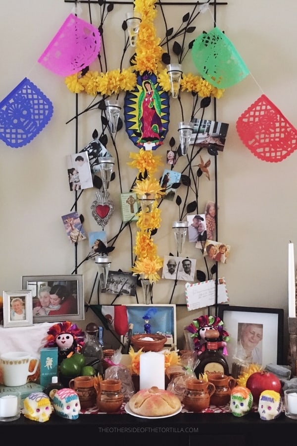 Mexican Day of the Dead altar with pan de muerto and other symbolic elements