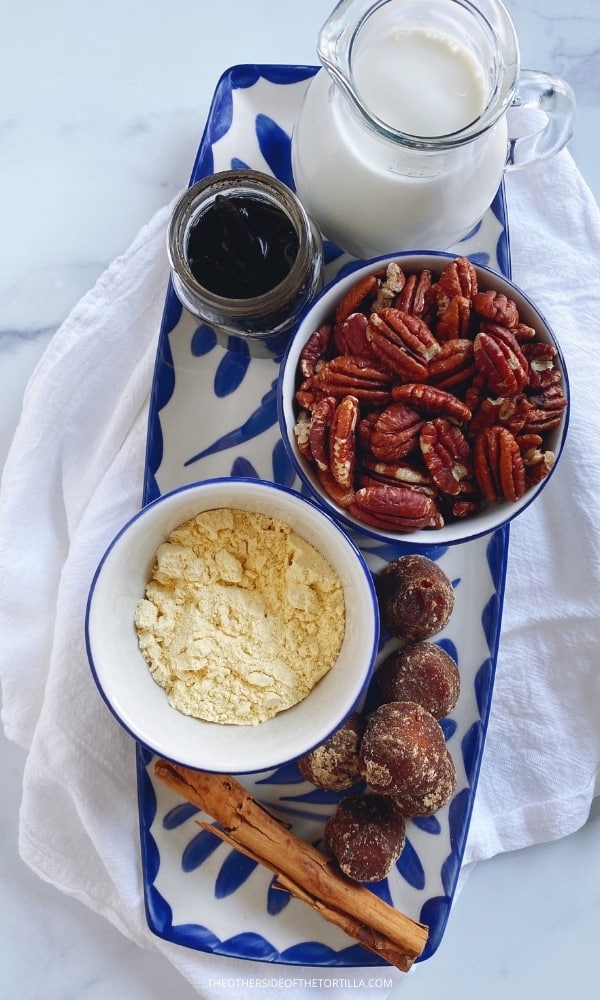 ingredients for atole de nuez on an oblong mexican talavera pottery tray