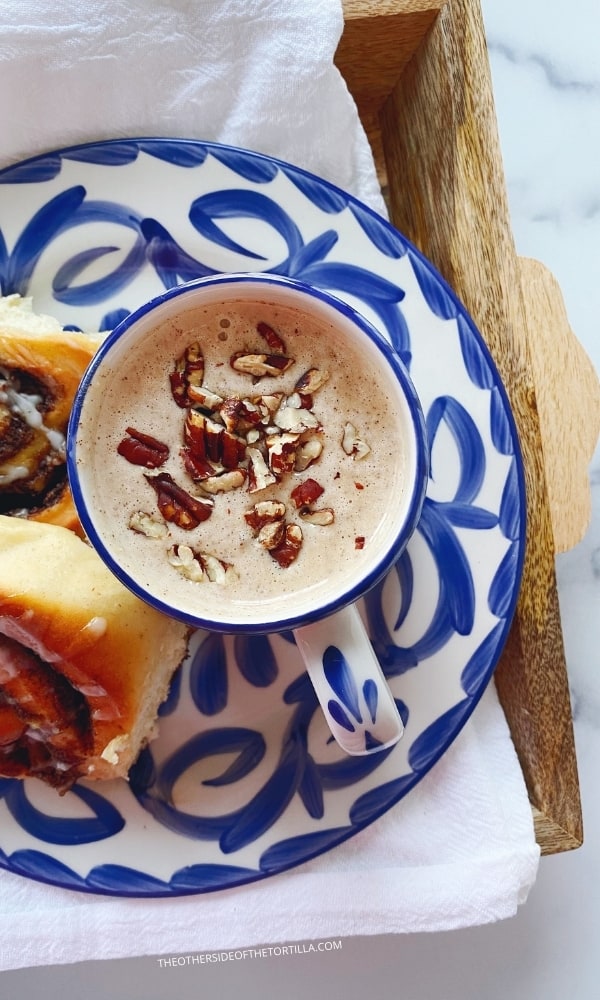 a mug of atole de nuez served on mexican talavera pottery with pan dulce