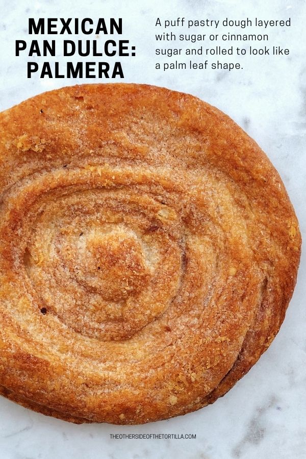 Mexican pan dulce palmera puff pastry circle on white marble background